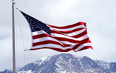 image of an American flag with Pikes Peak in the background