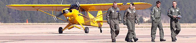 Image of cadets on the runway with Piper Super Cub in the background